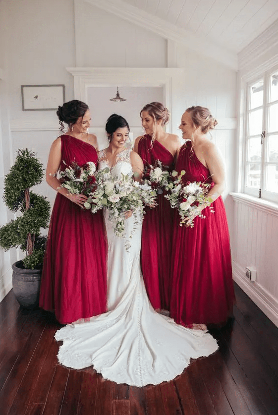 Lovely deep red one shoulder A line maxi bridesmaid dresses with draped bodices and skirts for a Christmas wedding