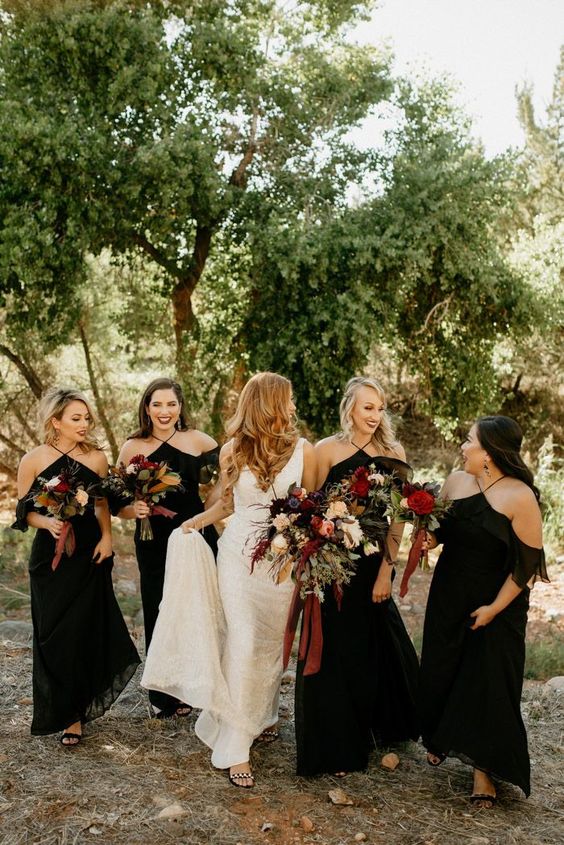 lovely matching black maxi bridesmaid dresses with halter neckls and black shoes for a sophisticated fall wedding