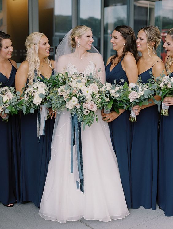 lovely matching navy maxi bridesmaid dresses with straps and draped bodices will do for any wedding