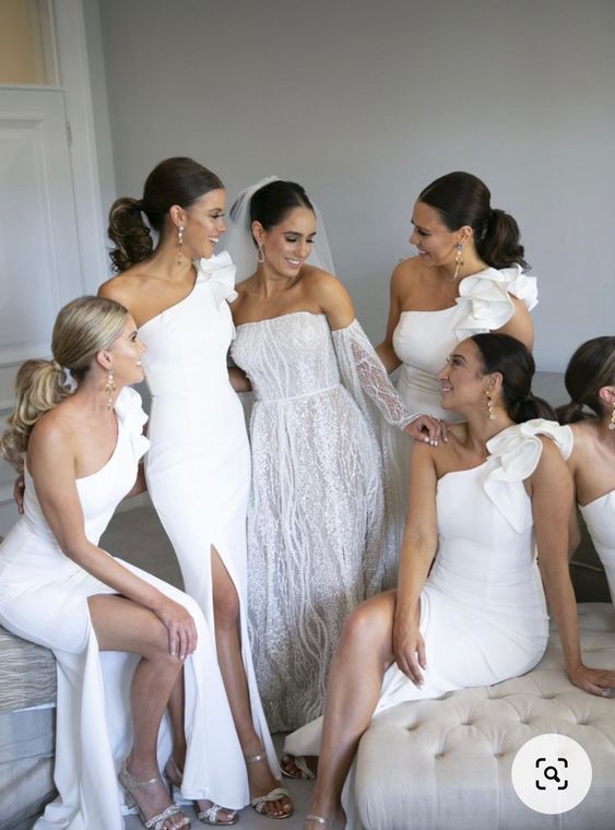 lovely white one shoulder maxi bridesmaid dresses with ruffles on the shoulders are a cool idea for a spring or summer wedding