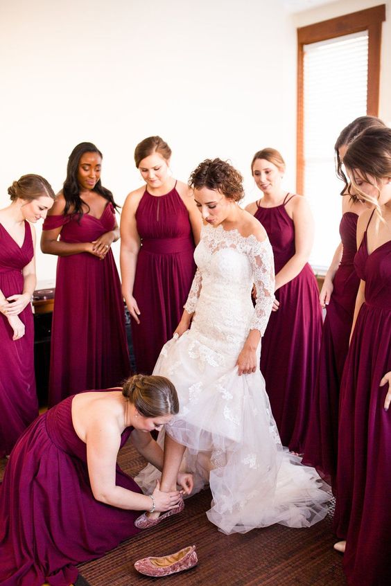 maroon-colored maxi bridesmaid dresses with draped bodices and pleated skirts are cool for a fall wedding