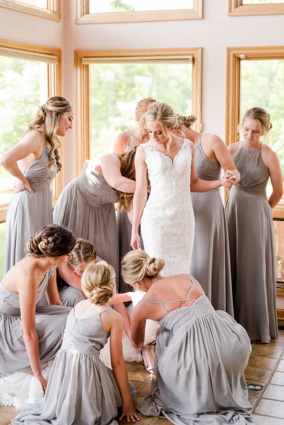 matching light grey halter neck maxi bridesmaid dresses with draped bodices and pleated skirts are lovely for spring or summer