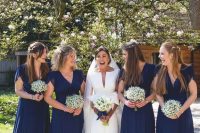 matching navy maxi bridesmaid dresses with short sleeves and V-necklines are a stylish and chic idea