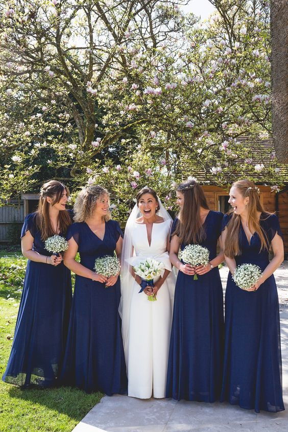 matching navy maxi bridesmaid dresses with short sleeves and V-necklines are a stylish and chic idea