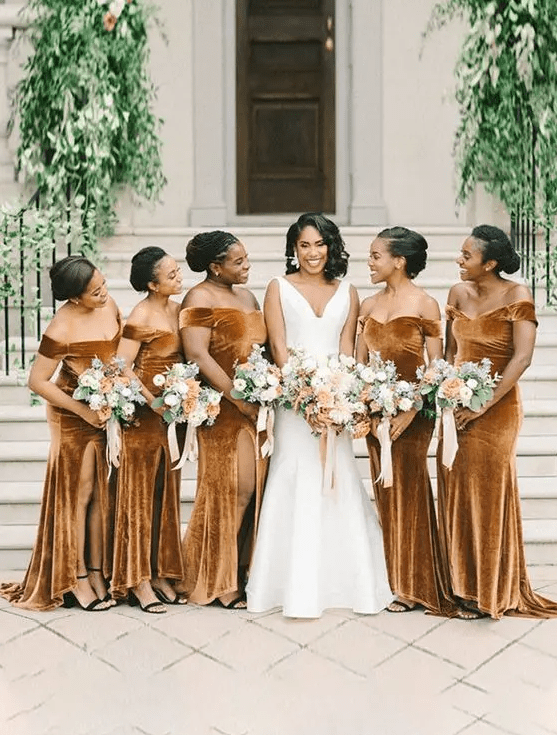 matching rust off the shoulder mermaid bridesmaid dresses with front slits and black shoes for a fall wedding