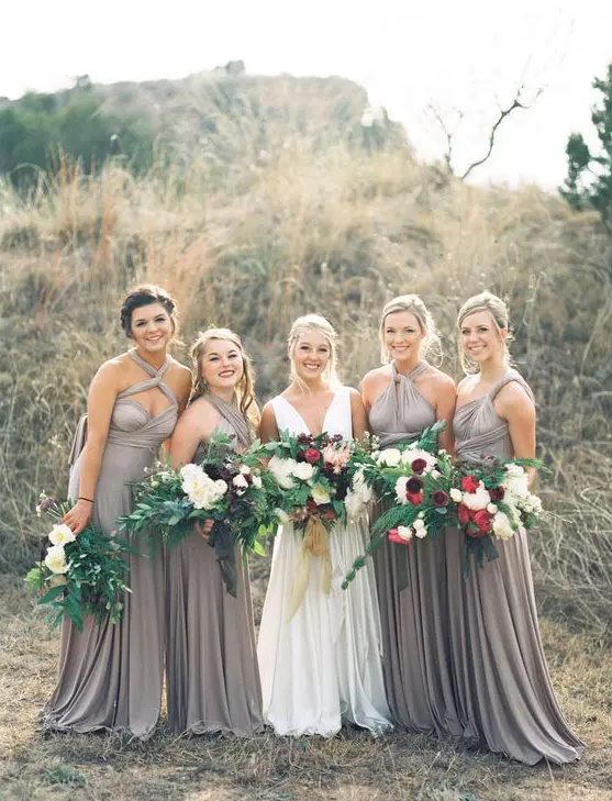 maxi grey bridesmaid dresses with mismatching necklines and pleated skirts are great for a summer or fall wedding