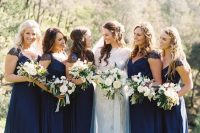 maxi navy bridesmaid dresses with lace cap sleeves and V-necklines, draped bodices for an elegant and timeless wedding