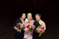 mismatched black maxi bridesmaid dresses with a V and halter neckline and pleated skirts for a bold wedding