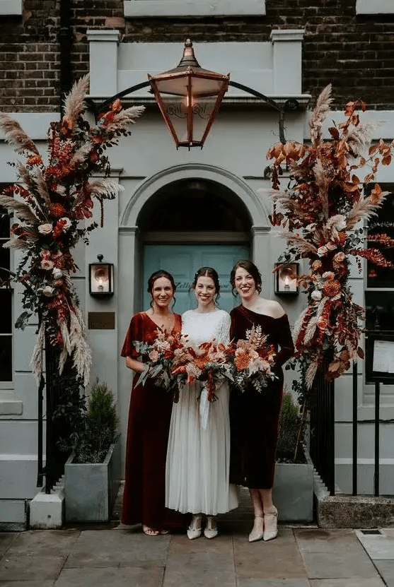 Mismatching burgundy and rust colored velvet bridesmaid dresses are awesome for a fall wedding