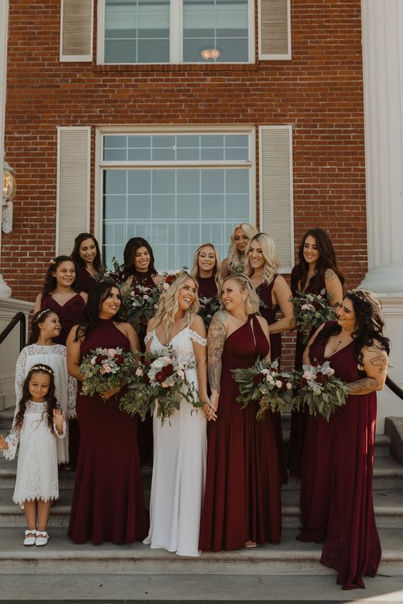 mismatching burgundy maxi bridesmaid dresses with halter and V necklines for a stylish fall wedding