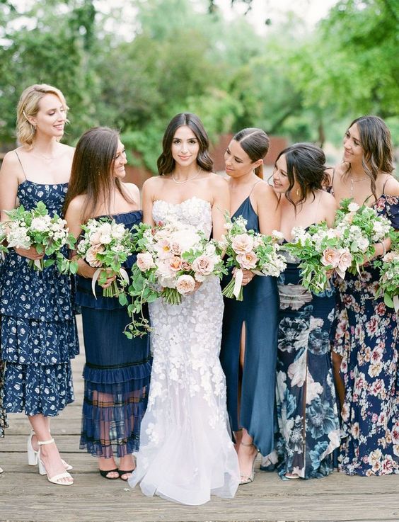 mismatching navy floral and plain maxi bridesmaid dresses are a cool solution for a flower-filled or boho wedding