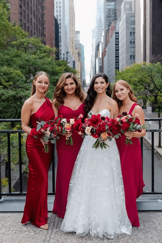 mismatching red maxi bridesmaid dresses are a great idea for a bold and colorful fall wedding