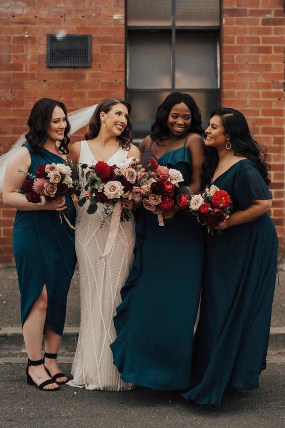 mismatching teal bridesmaid dresses including a midi one shoulder one are a cool idea for a bold fall wedding