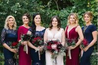 navy and fuchsia maxi dresses with lace inserts highlight the white dress of the bride very well