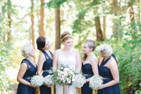 navy maxi bridesmaid dresses with baby’s breath bouquets and gold ribbons are geat for a modenr glam wedding