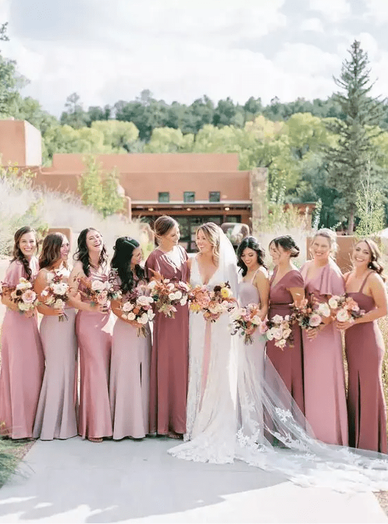 pale pink, blush and mauve maxi mermaid bridesmaid dresses with various necklines but a cohesive look