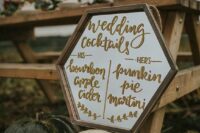 pumpkins holding a hexagon bar menu are a cool solution to highlight the rustic style of your wedding and add a bit of coziness to the space