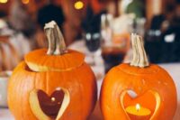 pumpkins with cutout hearts and candles inside will be a great decoration for tables, sweets tables and just for the venue