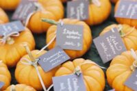 pumpkins with tags can be a nice idea for a fall wedding rehearsal dinner