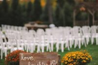 rustic fall wedding decor with a sign, pumpkins, bright potted blooms is a lovely idea for a rustic fall wedding ceremony space