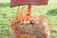rustic fall wedding decor with hay, pumpkins, bold blooms and a sign is a cool idea to make yourself