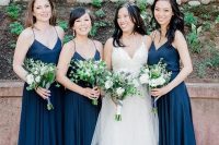 simple navy spaghetti strap maxi dresses and greenery and white bloom bouquets for a chic and bold navy and green wedding