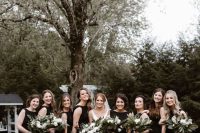 sleeveless black maxi bridesmaid dresses with high necklines are a chic and timeless idea for a wedding