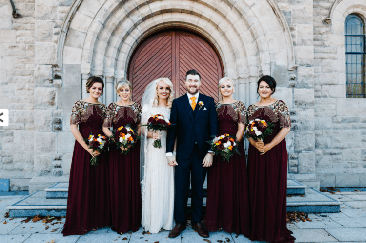 The bride was rocking a vintage-inspired dress, bridesmaids were wearing burgundy and gold