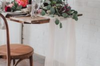 06 The delicate fabric table runner and florals soften the industrial space