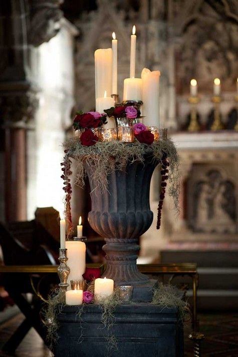 candles and flowers in a vintage urn