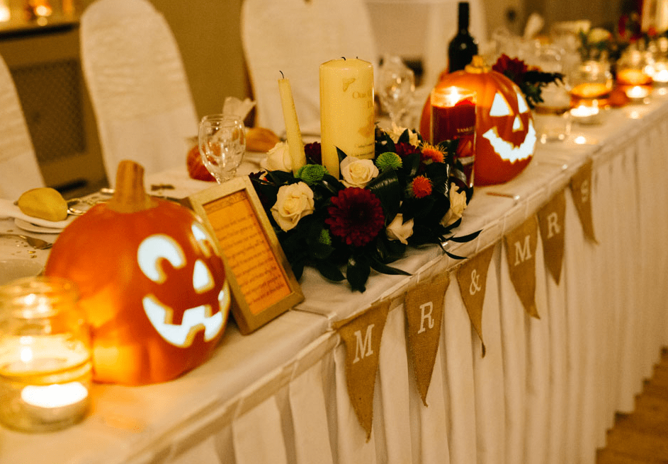Jack o lanterns, burlap, candles and bold fall flowers created an ambience
