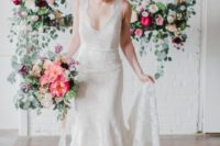 08 The bride was wearing an elegant ivory lace wedding dress with a plunging neckline and a train