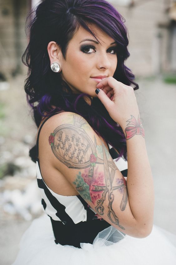 punk rock bride with purple hair showing up her tattoos
