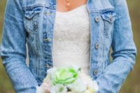 a denim cover up over a lace and bead wedding dress is a cool way to calm a very refined and chic wedding dress down giving you a more casual look