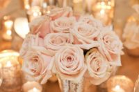 11 blush rose centerpiece in a gold vase