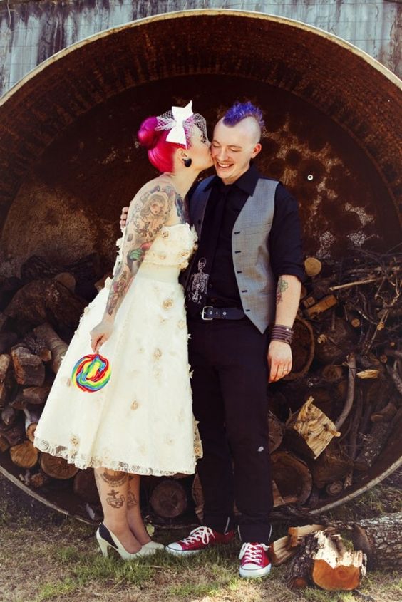 punk rock groom dressed in black with purple hair and red Converse
