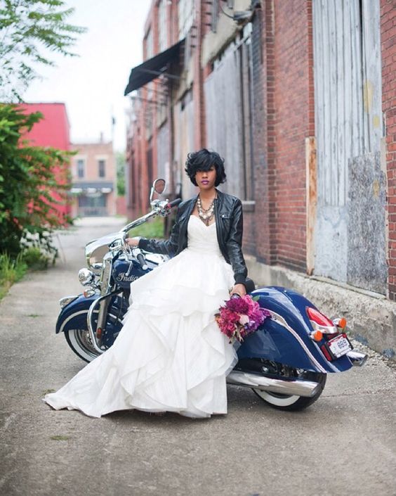 ruffled wedding dress with a black zip leather jacket and a statement necklace