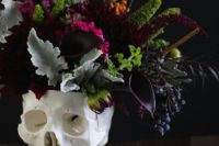 12 moody flowers and leaves in a skull vase