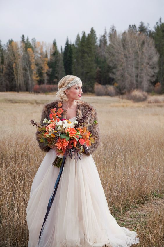 fur shawl is a fashionable touch to the bride’s ensemble