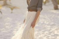 a beach bride in a boho lace dress and a chambray shirt with a brown belt