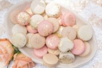 26 blush and cream macarons with gold glitter