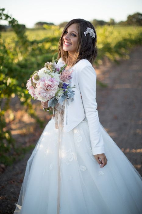 wedding ball gown with a cropped white leather jacket