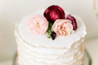 29 ruffled white cake with blush and burgundy flowers