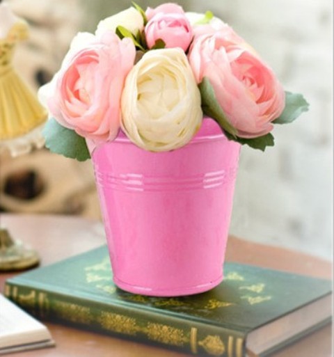 Bright pink bucket with yellow and pink roses