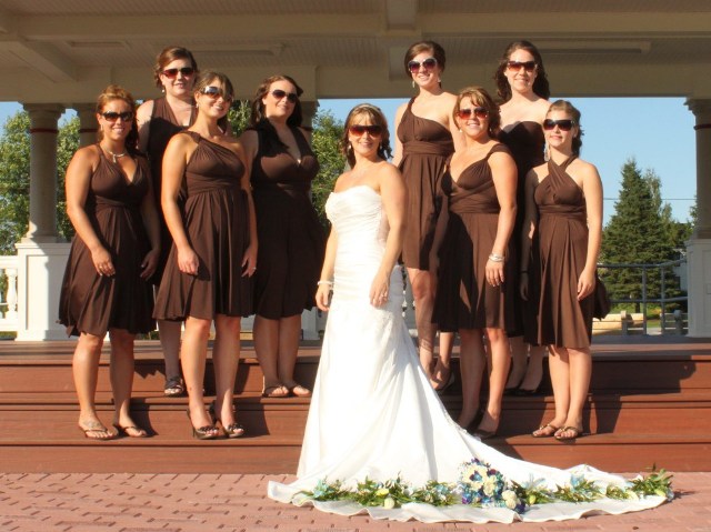 knee-length brown bridesmaid dresses with mismatching necklines paired with neutral shoes will fit many weddings