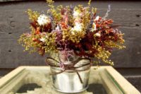 Table centerpieces with fall flowers and twine