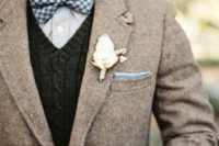With plaid bow tie, knitted waistcoat and white flower boutonniere