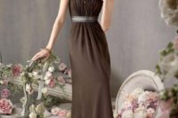 a refined brown maxi bridesmaid dress with a sash and some jewelry for a chic wedding