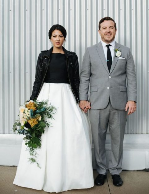 a black and white A-line wedding dress and a black leather jacket for a modern bride