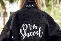 a black denim bridal jacket with black pearl embellished shoulders, white calligraphy and a wedding date is a cool idea